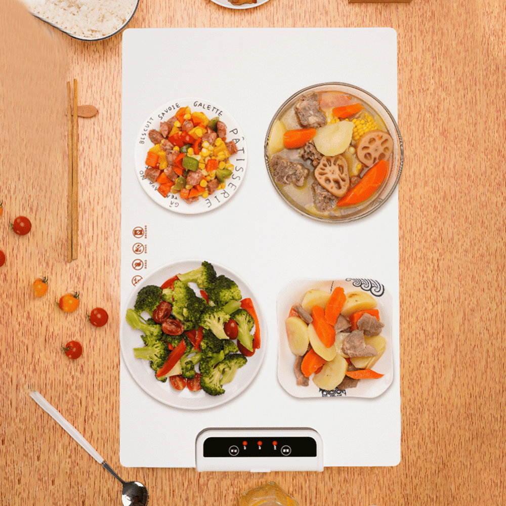 Top-down view of foldable food warmer heating various meals simultaneously on dining table