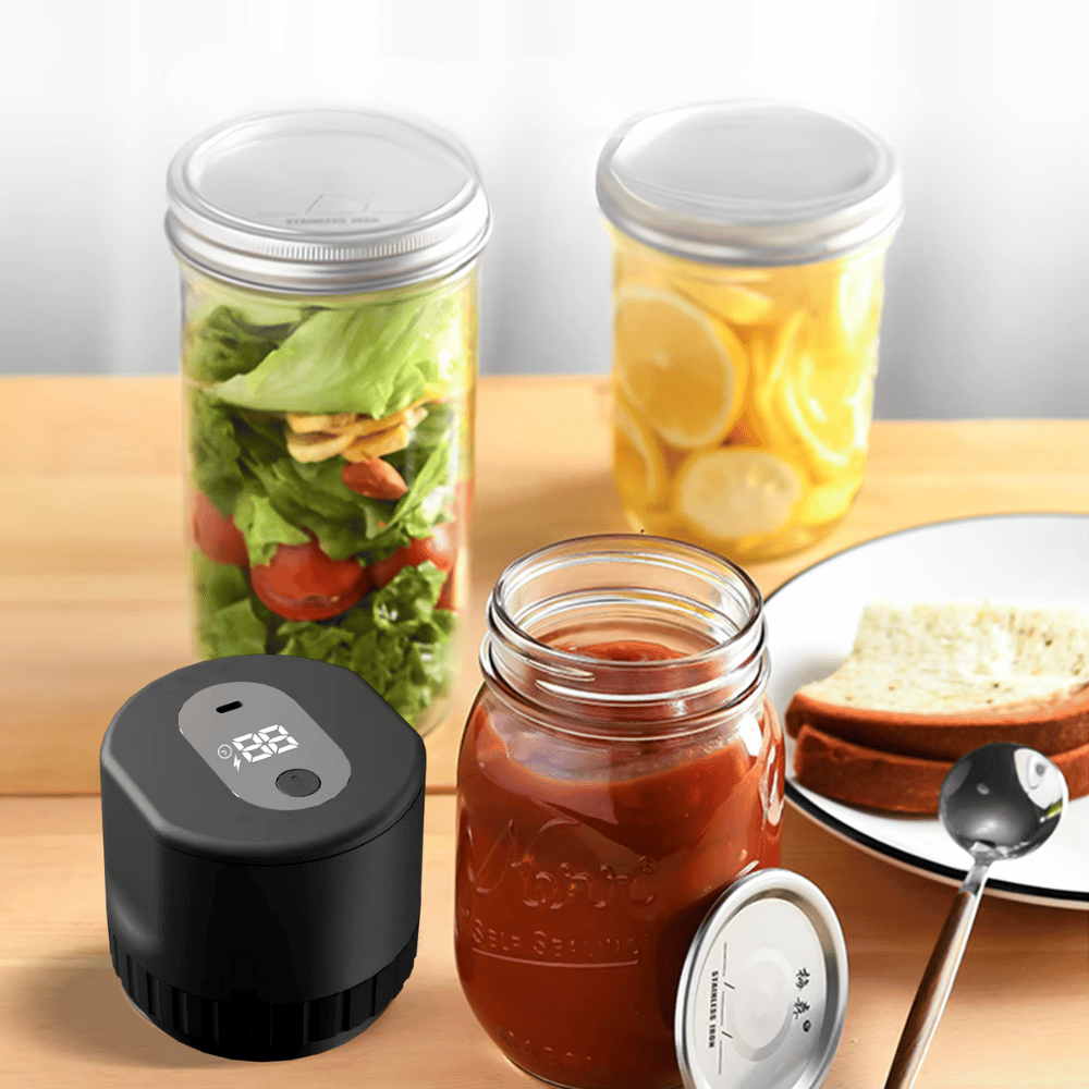 Electric jar vacuum sealer next to jars with preserved vegetables and jams for extended shelf life
