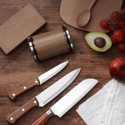 Sharpened kitchen knives beside rolling sharpener on cutting board setup