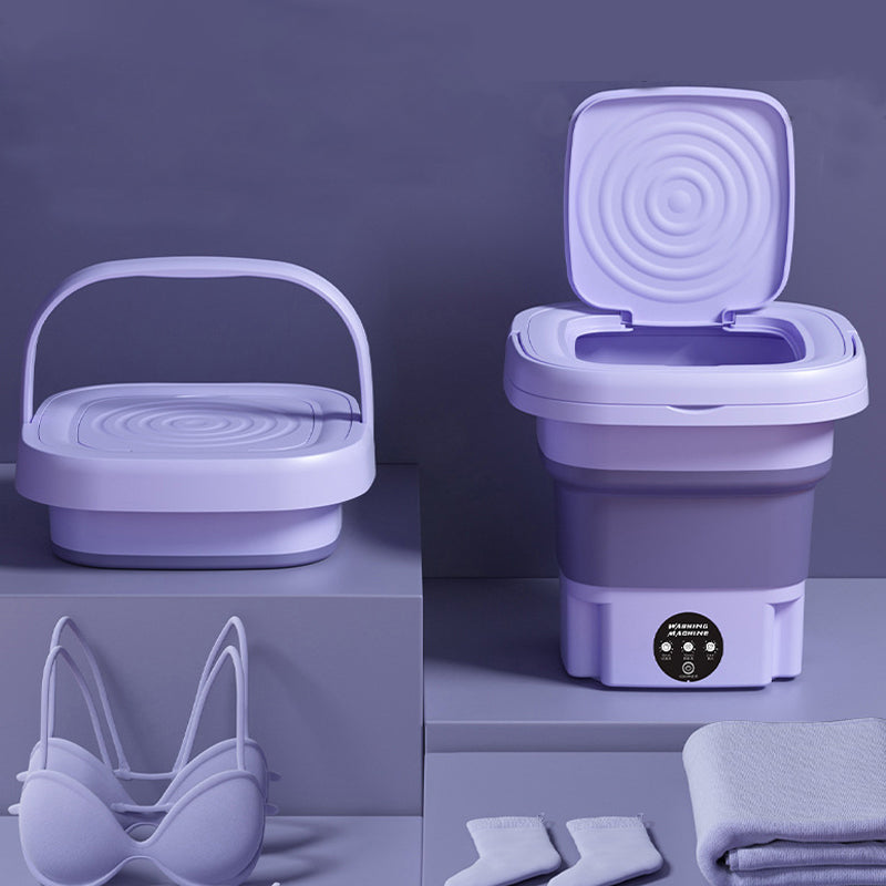 Open foldable washing machine next to shoes and towels, ideal for delicate fabrics and small items