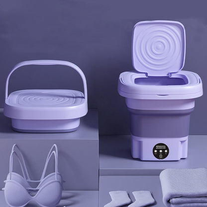 Open foldable washing machine next to shoes and towels, ideal for delicate fabrics and small items