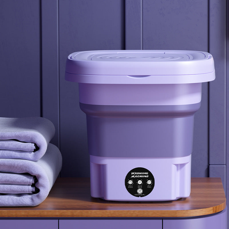 Foldable washer placed near towels, perfect for tight storage in bathrooms or laundry nooks
